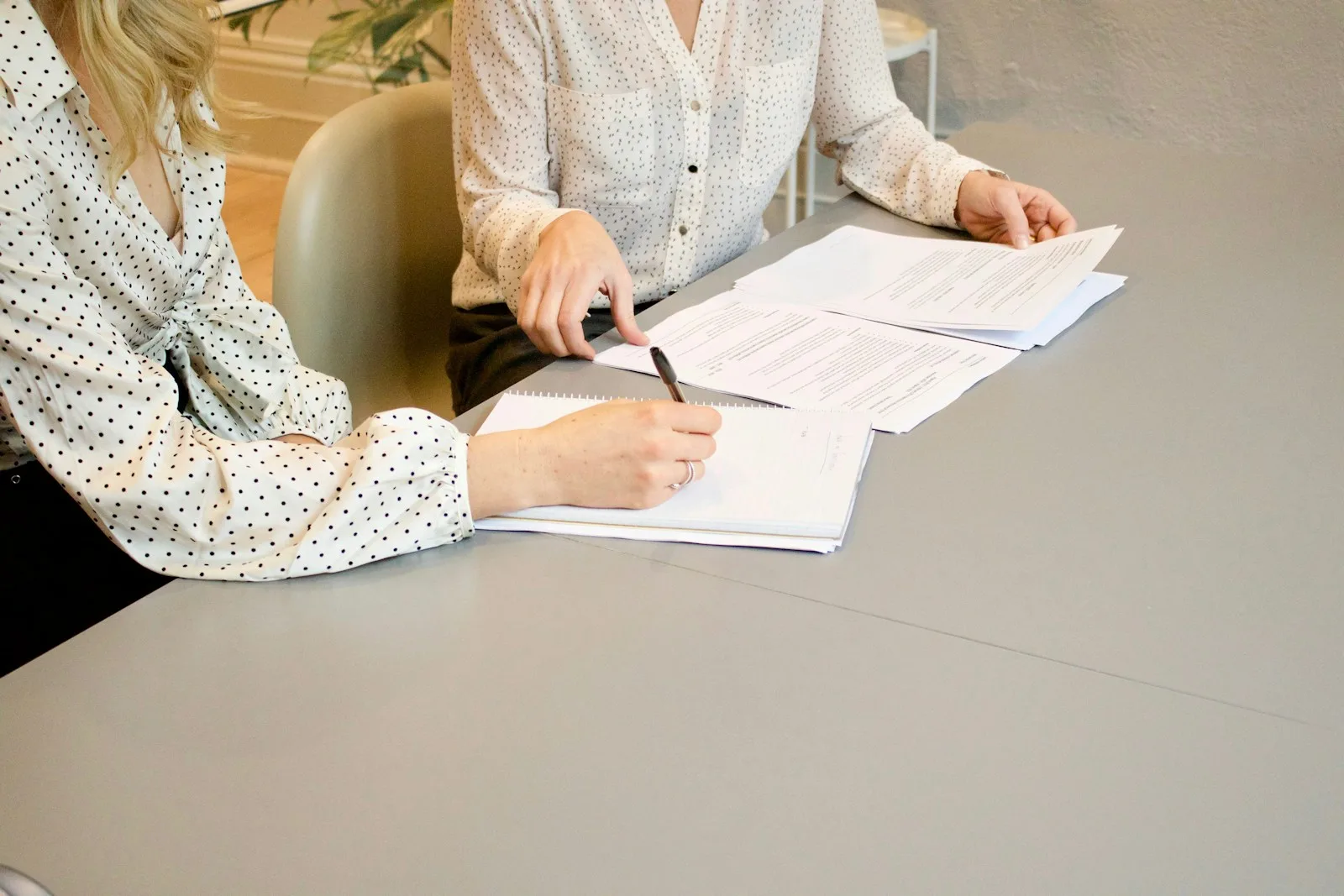 Dos personas revisando un presupuesto de proyecto sobre una mesa de trabajo